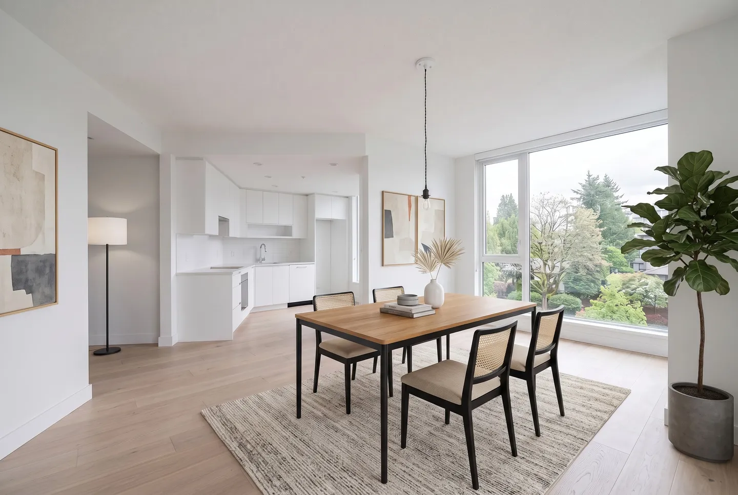 A dining area after Viara Studio staged it: furniture, rugs, lamps and art added.