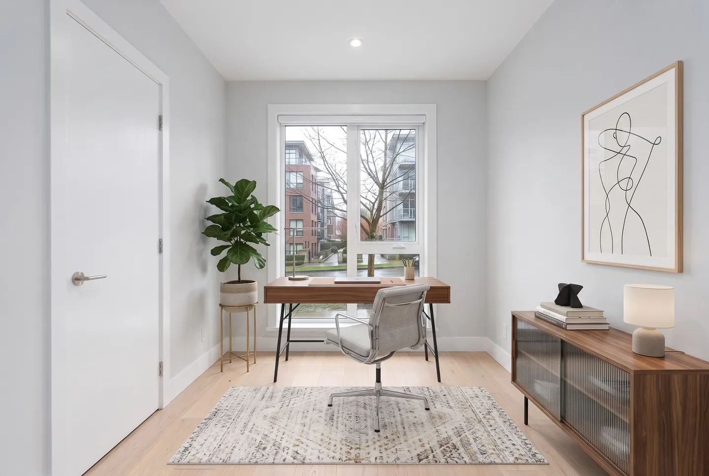 A den after Viara Studio staged it: furniture, rugs, lamps and art added.